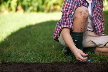 Image showing Legs, hands and child gardening with soil in nature for ecology and development education. Kid, dirt and planting in yard and playing in backyard for environmental landscaping in summer leisure