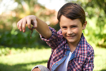 Image showing Boy, smile and portrait holding a worm in a garden for fun learning, development and growth. Curious, happy and young male person with a bug animal in nature for ecology education in environment