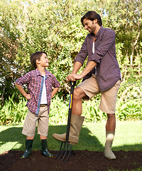 Image showing Child, father and smile with gardening in nature using tools for agriculture help and ecology education. Soil, bonding and a man teaching boy kid to plant with fork for organic earth growth