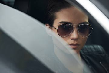 Image showing Window, car and face of woman with sunglasses for cool style and accessory while driving on a trip. Edgy, trendy and eyewear with a fashionable female person in a transport vehicle for journey