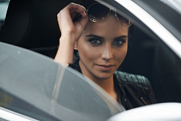 Image showing Woman, car and portrait while driving for a roadtrip commute in a luxury vehicle. Female person, face and window of a transportation motor for trip with confidence to travel destination