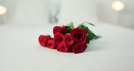 Image showing Romance, flowers and roses in bedroom for love on valentines day, anniversary celebration and honeymoon. Red rose, bouquet and closeup of florals on bed for romantic date, occasion and luxury in home