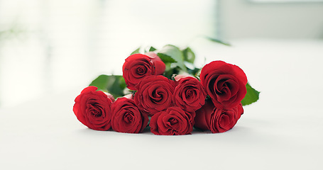 Image showing Romance, flowers and roses on bed for love on valentines day, anniversary celebration and honeymoon. Red rose, bouquet and closeup of florals in bedroom for romantic date, occasion and luxury in home