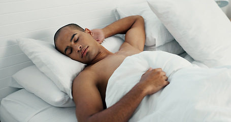 Image showing Man, resting and sleeping in bed at home, peace and dreaming or relax on sunday morning. Male person, comfortable and blanket for stress relief, lazy and house nap on soft bedding and calm on weekend