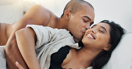 Image showing Happy couple, hug in bed and love with intimacy and romance at home for relationship, sex and bonding. Young people, woman and man relax in bedroom, cuddle and laughing with kiss and talking together