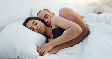 Image showing Couple, hugging and sleeping in bed together, love and resting or comfortable at home on weekend. People, bedroom and security in embrace, bonding and nap on sunday morning and relaxing or dreaming