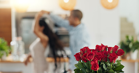 Image showing Roses, valentines day and home with couple dancing for love celebration in a kitchen with waltz. Gift, flower present and floral bouquet with happy people with music, marriage and care together