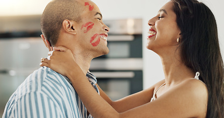 Image showing Happy couple, love and kiss with lipstick for fun date and playful at home in intimacy, romance and valentines day. Lover, woman and man in kitchen or house with lip print on cheek for anniversary