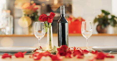 Image showing Wine, flowers and romance on valentines day for celebration of love, anniversary or honeymoon in still life. Glass, dinner and elegant date in dining room of home for event, milestone or occasion