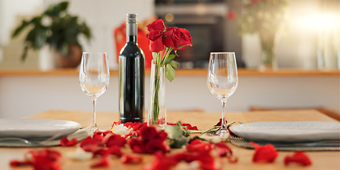 Image showing Wine, flowers and romance on valentines day for celebration of love, anniversary or honeymoon in still life. Glass, dinner and elegant date in dining room of home for event, milestone or occasion