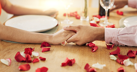 Image showing Couple, roses and holding hands on dinner date, anniversary or valentines day dining by table at home. Closeup of man and woman in celebration or care for romantic honeymoon, embrace or love at house