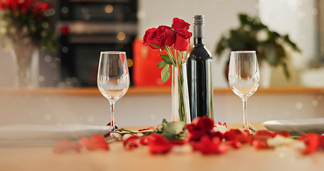 Image showing Wine, glass and romance on valentines day for celebration of love, anniversary or honeymoon in still life. Flowers, dinner and elegant date in dining room of home for event, milestone or occasion