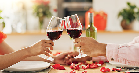 Image showing Couple, hands and toast with wine glass for home celebration of love, romance and valentines day on anniversary. People, table and date success with red champagne, drinks or luxury dinner with roses