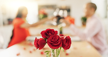 Image showing Couple, roses and toast at home with wine glass for celebration of love, romance and valentines day. People cheers for date success, drinking red champagne and luxury dinner at a table with flowers