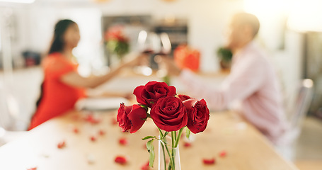 Image showing Couple, roses and toast at home with wine glass for celebration of love, romance and valentines day. People cheers for date success, drinking red champagne and luxury dinner at a table with flowers