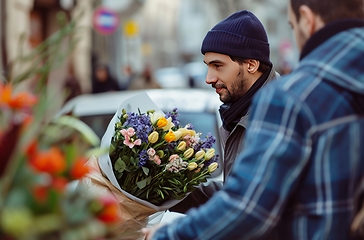 Image showing Man Holding Bunch of Flowers in Hands