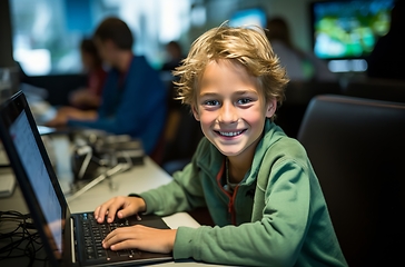 Image showing Young Boy Sitting in Front of Laptop Computer