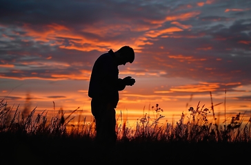 Image showing Man Standing in Field at Sunset, Captivating Serenity in Natures Embrace