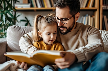 Image showing Man Reading Book to Little Girl, Enriching Learning Experience and Bonding Moment