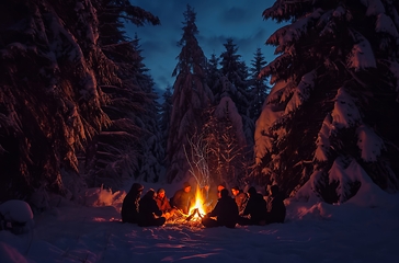 Image showing Group of People Sitting Around Fire in Snow
