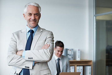 Image showing Senior businessman, portrait and confidence or mentor, agency and pride for training in office. Happy male person, arms crossed and smile for support in management, advisor and laptop for planning