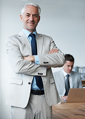 Image showing Senior businessman, portrait and confidence in leadership, agency and pride for mentoring in office. Male person, arms crossed and smile for support in management, advisor and laptop for planning