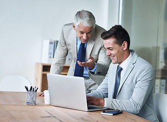 Image showing Senior businessman, employee and laptop for advice, leadership and mentor on technology. Businesspeople, consulting and support or feedback on report, proposal and discussion or teaching in office