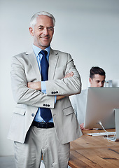 Image showing Senior businessman, portrait and confidence in career, agency and pride for mentoring in office. Male person, arms crossed and smiling for support in management, advisor and computer for planning