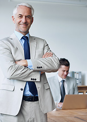 Image showing Senior businessman, portrait and confidence in management, agency and pride for mentoring in office. Male person, arms crossed and happy for support in training, advisor and laptop for planning