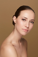 Image showing Skincare, beauty or portrait of natural woman in studio isolated on brown background for pride or wellness. Smooth face, body cosmetics or confident model or healthy female person with shine or glow