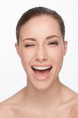 Image showing Portrait, smile and woman wink for skincare, flirt or beauty makeup isolated on white studio background. Face, blink and happy model in cosmetics excited for spa facial treatment for healthy skin