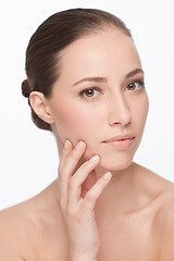 Image showing Woman, hand on face and skincare for natural beauty, hygiene and wellness with dermatology and self care on white background. Portrait, facial and touching skin, glow and cosmetics in studio