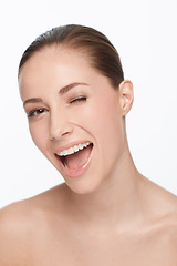 Image showing Portrait, happy and woman wink for beauty, flirt or skincare isolated on white studio background. Face, blink and smile of model in makeup cosmetics excited for spa facial treatment for healthy skin