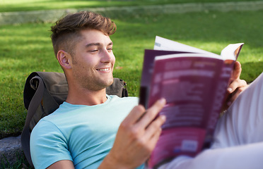 Image showing Man, student and book on grass for reading, smile and ideas with learning for development at campus. Person, studying and happy with scholarship, information and knowledge for education at college