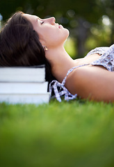 Image showing Books, grass and woman on campus relax, calm and resting for studying, class and learning. Education, university and person outdoors for wellness, fresh air and peace with textbooks for knowledge