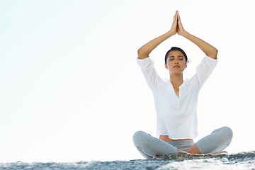 Image showing Woman, yoga and meditation at beach with space, peace and zen breathing with namaste hands over head. Girl, Indian person and outdoor with mockup, nature or holiday on sand for mindfulness in Mumbai