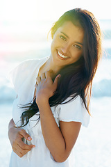 Image showing Arab woman, beach and smile for ocean, waves and breeze for summertime in Bali for vacation. Female, sea and holiday relaxation abroad in swimsuit, sand and happy for portrait, memories and trip.