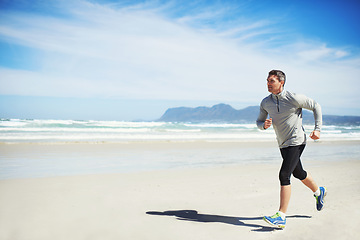 Image showing Sand, space or man at beach running for exercise, training or outdoor workout at sea for fitness. Sports person, mature runner or healthy athlete in nature for cardio endurance, wellness or mockup