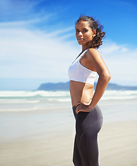 Image showing Portrait, beach and woman with fitness, vacation and summer with confidence and progress with challenge. Person, athlete and runner with holiday and workout with seaside break and relax with water