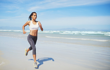 Image showing Fitness, space or Indian woman at sea running for exercise, training or outdoor workout at beach. Sports person, runner or healthy female athlete on sand for cardio endurance, wellness or mockup