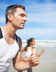 Image showing Mature, man or people on beach running for exercise, training or outdoor workout at sea. Sports couple, runners or healthy athletes in nature for fitness endurance, wellness or challenge on sand