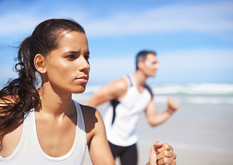 Image showing Fitness, woman or people on beach running for exercise, training or outdoor workout at sea. Sports couple, runners or healthy athletes in nature for cardio endurance, wellness or challenge on sand