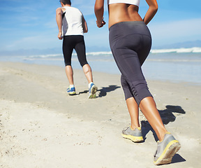 Image showing Running, beach and man with woman, fitness and cardio with workout and training for wellness. Healthy, runner and athlete with practice and vacation with water and waves with sunshine or getaway trip