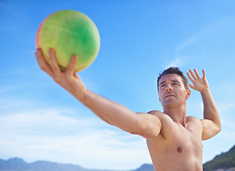 Image showing Beach, volleyball and man with fitness, vacation and sunshine with player and workout for wellness. Person, athlete and guy with fun and seaside with training and practice for health and adventure