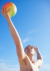 Image showing Beach, volleyball and man with fitness, holiday and sunshine with player and workout for wellness. Person, athlete and guy with summer and seaside with training and practice for health and vacation