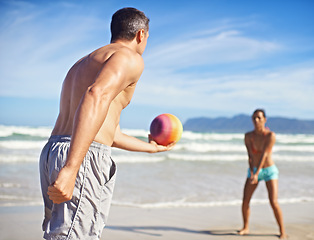 Image showing Game, beach and man with woman, volleyball and fitness with wellness and activity for health. Cardio, players and friends with holiday or seaside with water or waves with exercise, summer or training