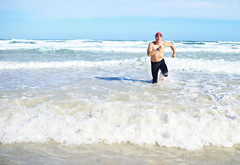 Image showing Beach, running and man with fitness, summer and water with waves and exercise with morning routine. Person, seaside and runner with fun and sunshine with cardio and ocean with workout and adventure