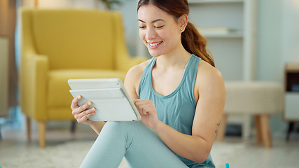 Image showing Fitness, internet and woman streaming on a tablet for training, yoga and exercise on the floor of her house. Happy, young and wellness girl with technology for a workout, cardio or video on pilates