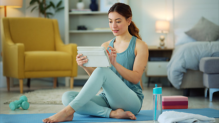 Image showing Fitness, internet and woman streaming on a tablet for training, yoga and exercise on the floor of her house. Happy, young and wellness girl with technology for a workout, cardio or video on pilates