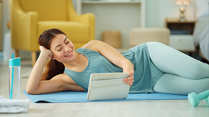 Image showing Fitness, internet and woman streaming on a tablet for training, yoga and exercise on the floor of her house. Happy, young and wellness girl with technology for a workout, cardio or video on pilates